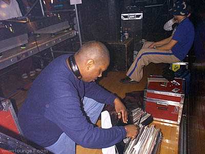 Donald Glaude (seattle) checks his records as Tobias admires his pants...
